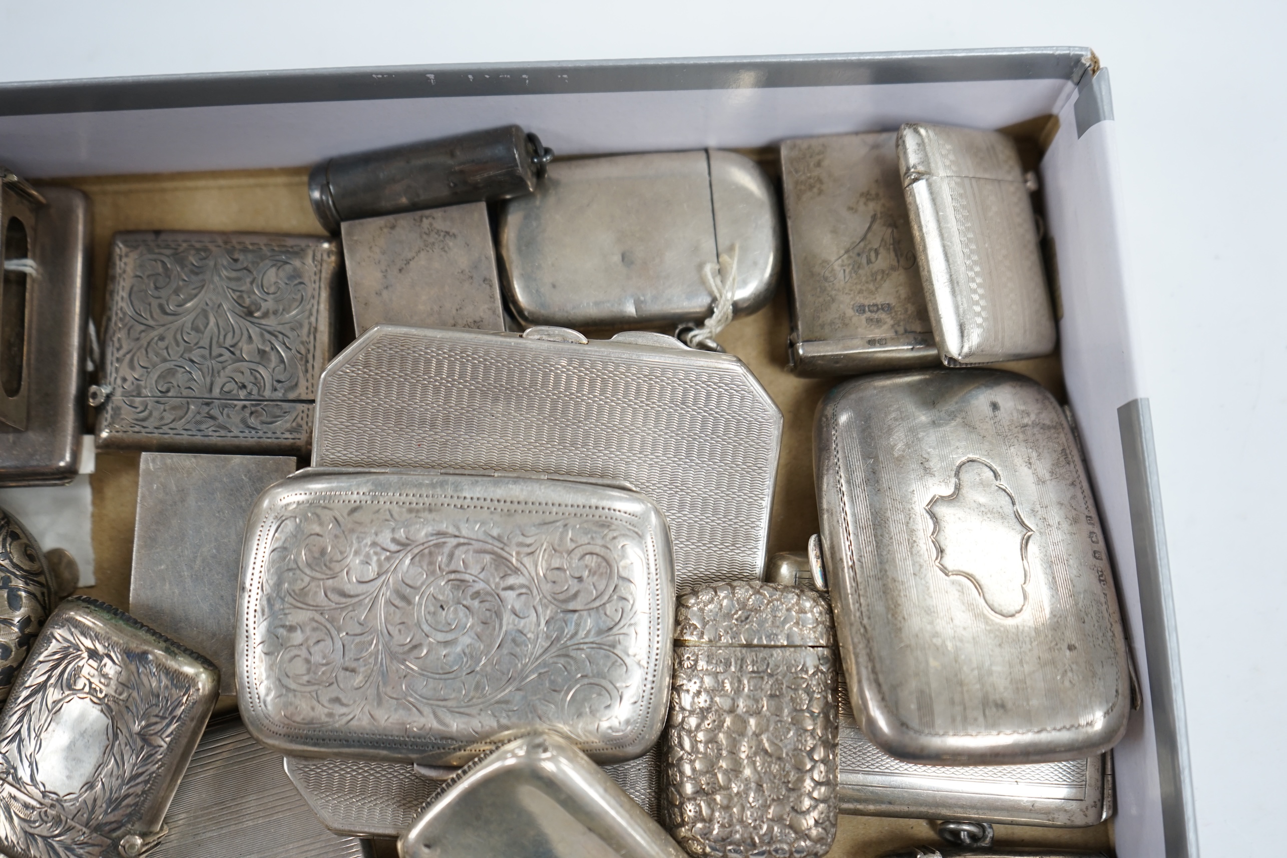 A collection of twenty four assorted silver vesta cases, eight cigarette cases, two match sleeves and a late 19th century Russian 84 zolotnik niello small tobacco box. Condition - poor to fair